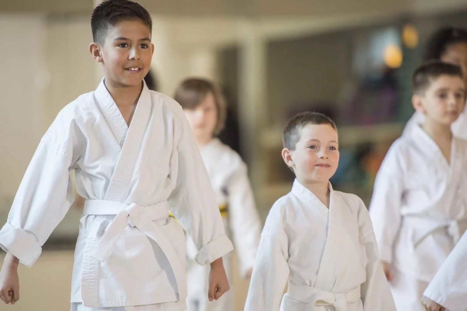 Martial arts students training in a traditional dojo, practicing discipline and technique under instructor guidance